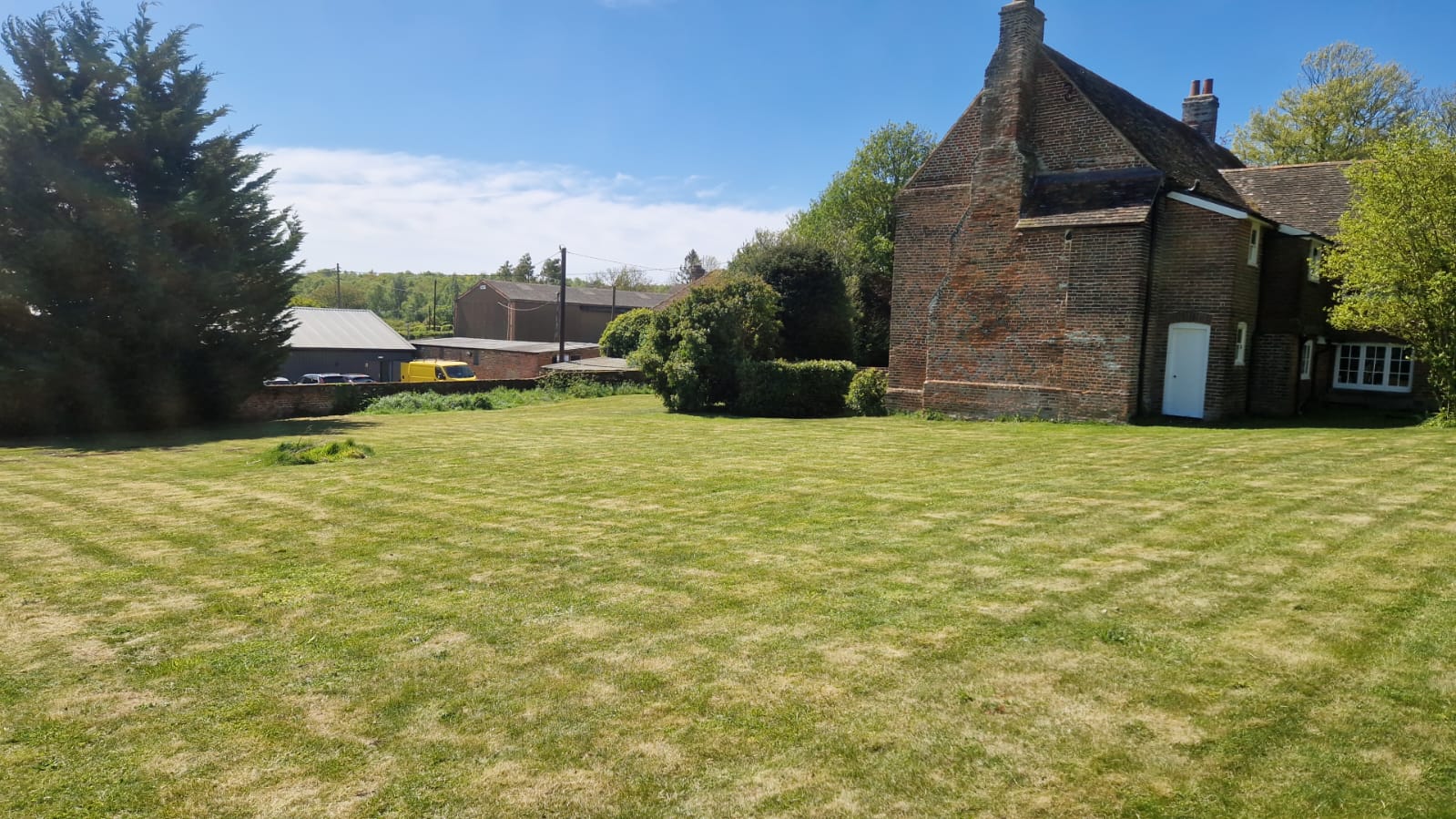 Kent Mowing freshly cut lawn at a rural farmhouse near Dover, East Kent